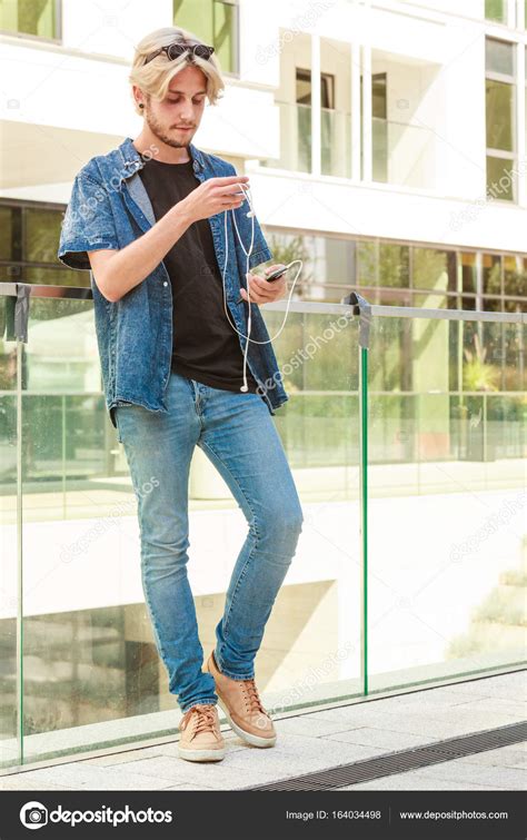 Hipster man standing on city street, urban fashion — Stock Photo © Anetlanda #164034498