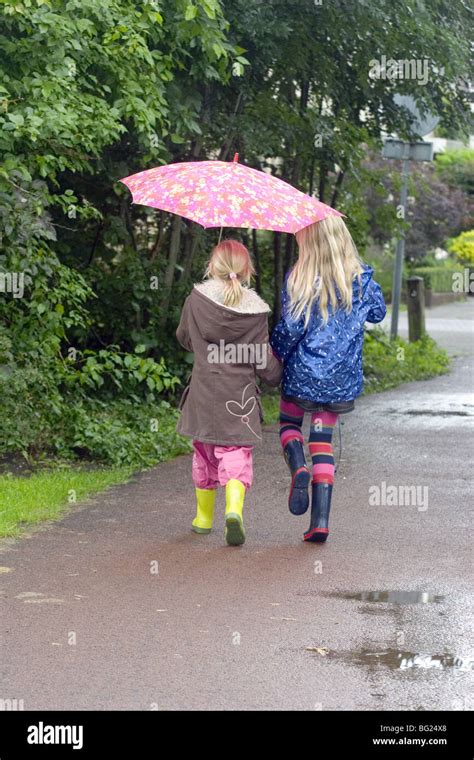 Children Walking School In Rain Stock Photos And Children Walking School