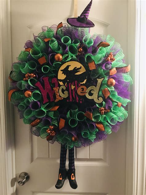 A Wreath That Has Been Decorated With Witchs Legs And The Words