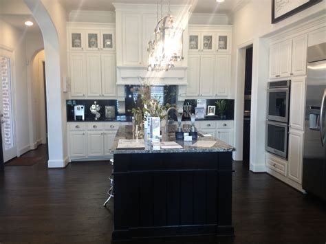 You can go with a darker stained look, but not too dark since the appliances are white. Ideas Gorgeous Black And White Kitchen Design Dark Wood Laminate Floor Espresso Wooden Island ...