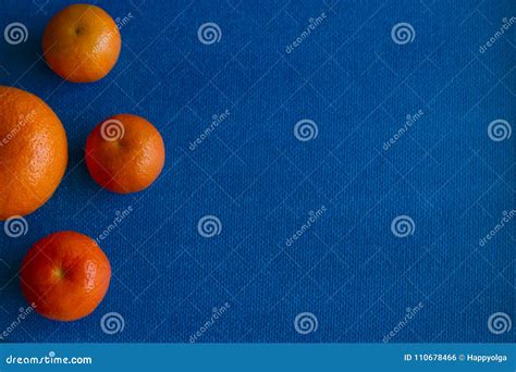 Four Orange Mandarins Are On Blue Background Stock Photo Image Of