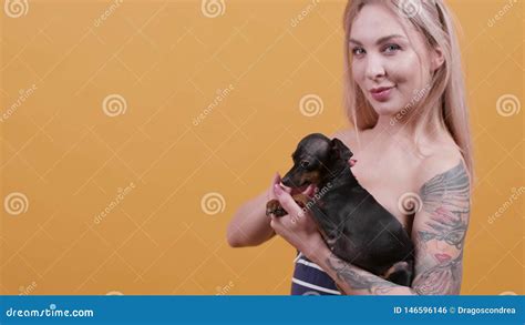 Portrait Of A Sensual Tattooed Blonde Girl And Her Pet Stock Footage