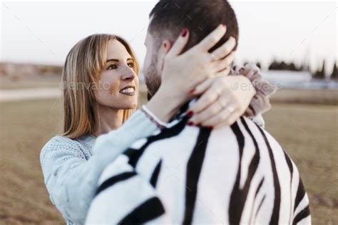 Female Looking Her Boyfriend Close Up Couple Nose Kissing In The Countryside Embraced Stock