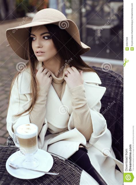 Glamour Girl With Dark Straight Hair Wears Luxurious Beige Coat With