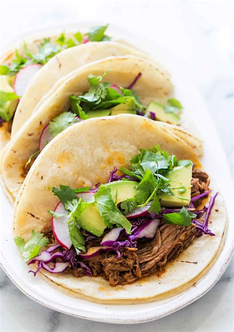 These skinny pulled pork sliders with red cabbage & avocado will be the star of your appetizer table. Slow Cooker Mexican Pulled Pork Recipe | SimplyRecipes.com