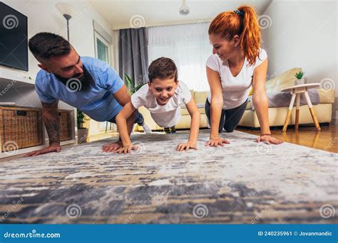 Morning Stretching Mother And Father With Son Doing Gymnastic Exercise At Home Stock Image