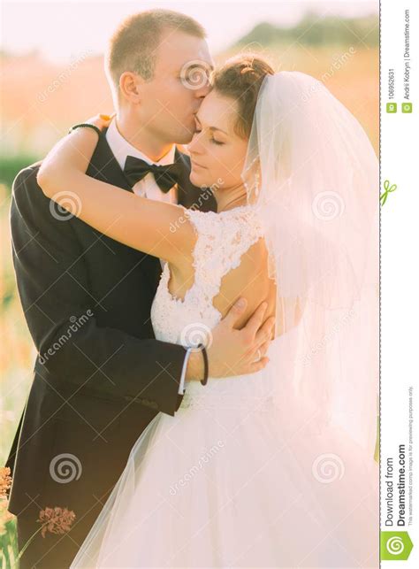 The Sensitive Close Up Portrait Of The Groom Kissing The Bride In The