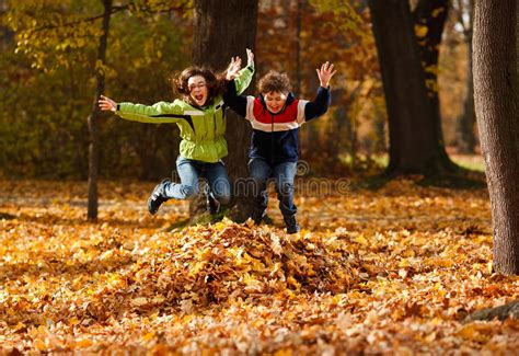 Kids Playing In Autumn Park Stock Photos Image 23097143