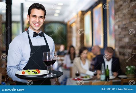 Professional Waiter Holding Serving Tray For Restaurant Guests Stock