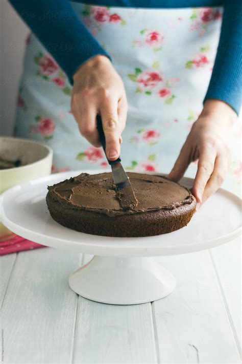 Woman Spreading Chocolate Buttercream Onto Cake By Kirsty Begg
