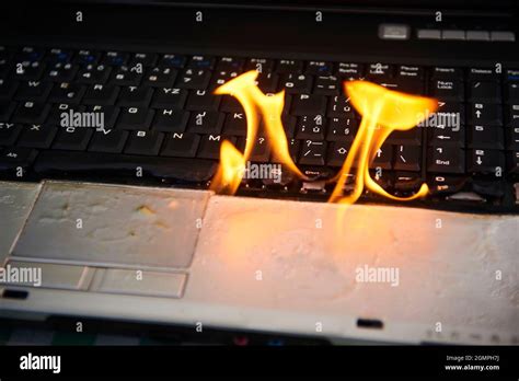 Laptop Burning In Flames On A Desk Fire Hazard Losing Valuable Data
