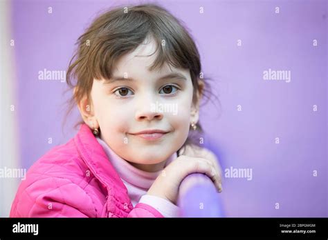 Six Year Old Brunette Girl Looking At The Camera Portrait Of A Little