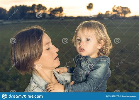 Close Up Of A Mother Hugging Her Little Daughter At Sunset Stock Image Image Of Togetherness