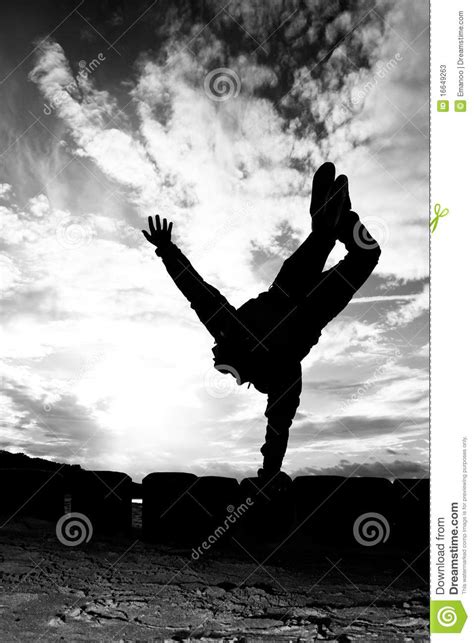 Silhouette Of Girl Doing A One Arm Handstand Stock Image