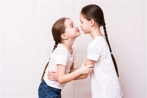 Two Girls Sisters Kiss Each Other When Meeting Stock Image Image Of