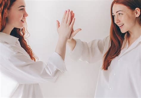 Premium Photo Two Red Haired Sisters Stand Isolated On A White