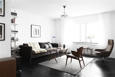 Definitive proof that modern living rooms are warm and inviting. Scandinavian livingroom with dark floor | Living room ...