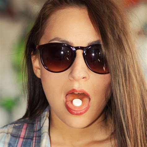 Beautiful Young Girl In Sunglasses Is Going To Swallow Pills Stock