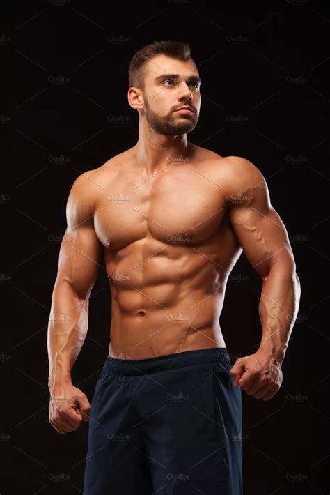 Fitness Muscular Man Is Posing And Showing His Torso With Six Pack Abs