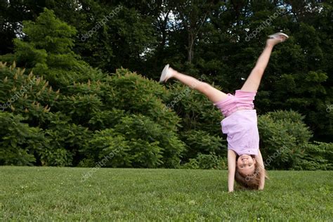 Little Girl Doing A Cartwheel — Stock Photo © Kmlphoto 11454454