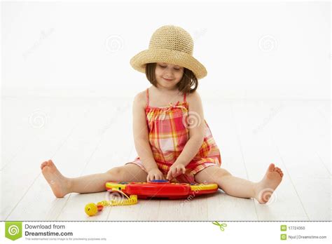 Little Girl Playing With Toy Instrument Stock Photo