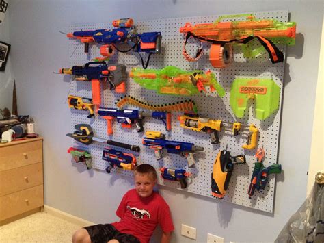 My husband hangs his nerf guns armory style in our bedroom. Nerf organization @Annette Howard Howard Olvera Saldivar ...