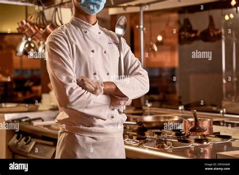 Proud Chef Standing With Crossed Arms In Kitchen Stock Photo Alamy