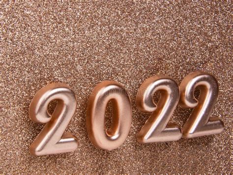 Bronze Decorative Shiny Numbers 2022 New Year On Gold Background With