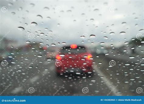 Road View Through Car Window With Rain Drops Driving In Rain Stock