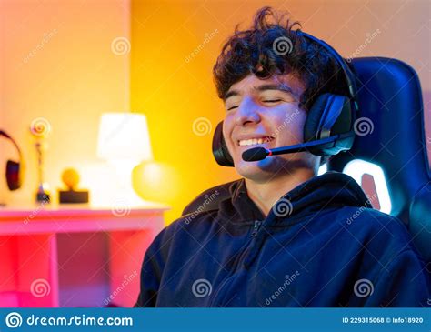Cheerful Gamer Using Headset With Mic Stock Photo Image Of Electronic