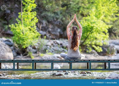 Young Woman Is Practicing Yoga At Mountain Lake Stock Image Image Of
