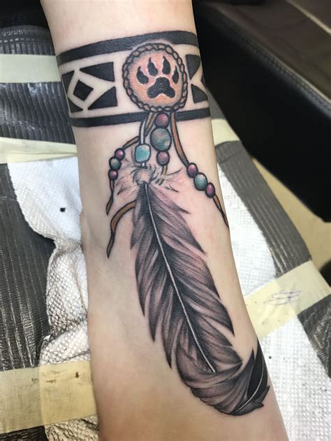 In native american culture, the feather is believed a symbol of spiritual protection. Creek Indian band with a lion paw medallion and eagle ...