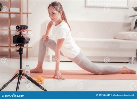 Fit Pretty Lady Providing An Online Stretching Lesson Stock Image