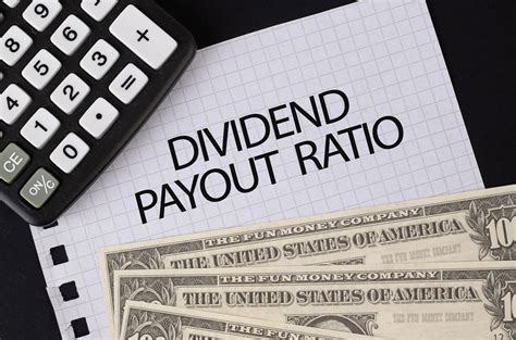 The relationship between dividends and earnings is important. Calculator, money and Dividend Payout Ratio text on black ...