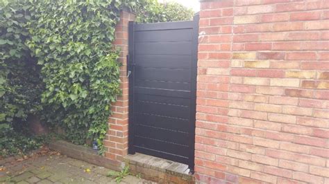 side gate and pedestrian gate in aluminium with solid infill horizontal infill flat top