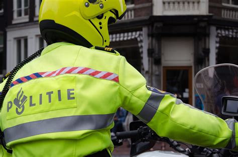 dutch police officer on motorbike patrolling in amsterdam the netherlands dutch police on