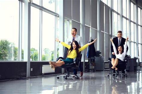 Premium Photo Cheerful Colleagues Having Fun In Office Chairs