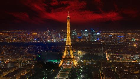 Eiffel Tower With Yellow Lighting And Paris City With Red And Black Sky