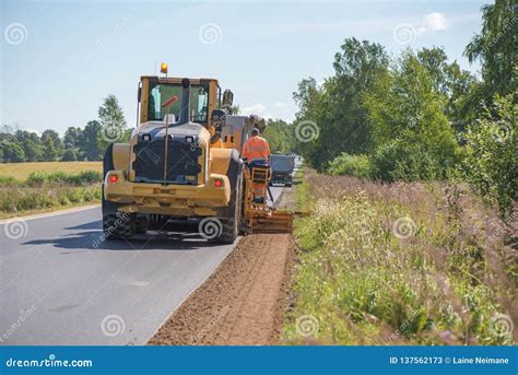 Road Construction Workers Repairing Highway Road On Sunny Summer Day