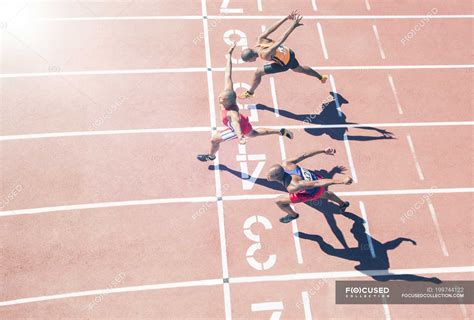 Runners Crossing Finish Line On Track — Competing Health Stock Photo