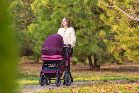 Mom Walks With Newborn Baby In Autumn City Park Stock Image Image Of