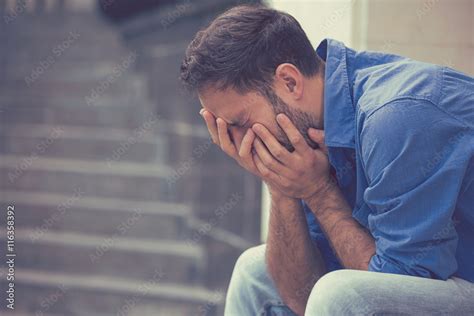 Stressed Sad Babe Crying Man Sitting Outside Holding Head With Hands Stock Photo Adobe Stock