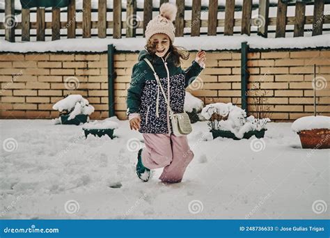 Little Girl In Snow Clothes Playing With The Snow After A Heavy