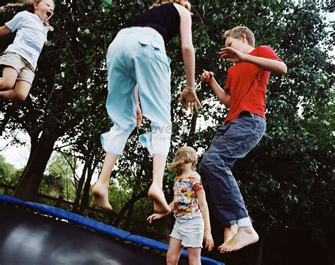 Child Jumping On Trampoline