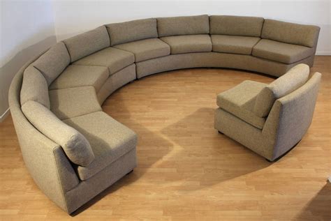 Curved barrel back and spring cushion wrapped in a beige/champagne mohair, rests on top of a brass plinth base. Milo Baughman Large Sectional Curved Sofa at 1stdibs