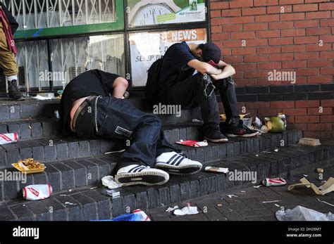 Two Drunk People Lay On The Floor At The Notting Hill Carnival Stock