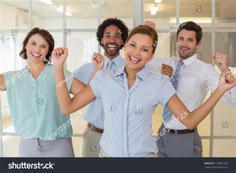 Portrait Of Cheerful Young Business Colleagues Cheering In The Office