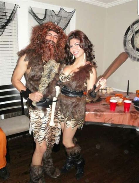 a man and woman dressed up as caveman and cheetah for halloween party