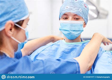 Doctor As Surgeon Putting On Protective Clothing Stock Image Image Of