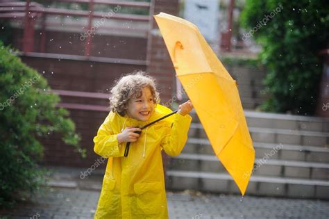 Haz tu selección entre imágenes premium sobre yellow raincoat boy de la más alta calidad. The amusing little boy in a yellow raincoat and with ...